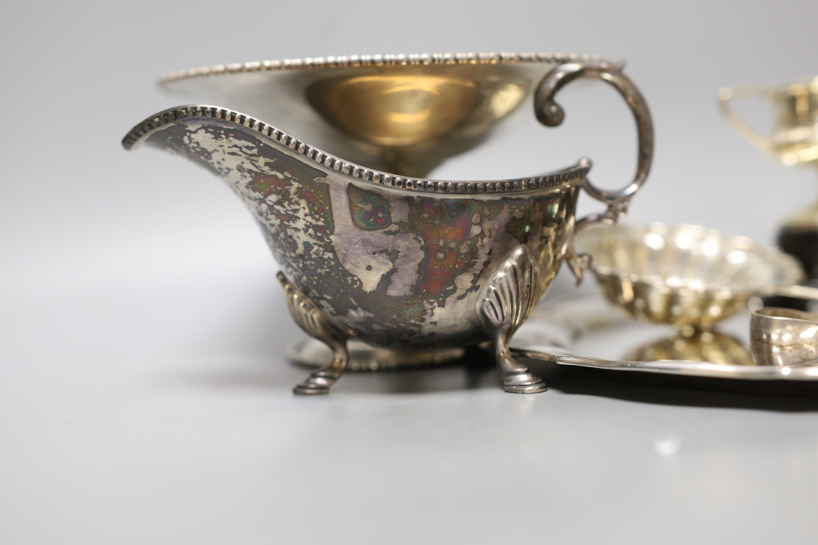 A George V silver salver, a silver tazze, a silver sauceboat, three silver condiments, a silver tea strainer, four items of silver flatware, three small silver trophy cups and two plated cups.